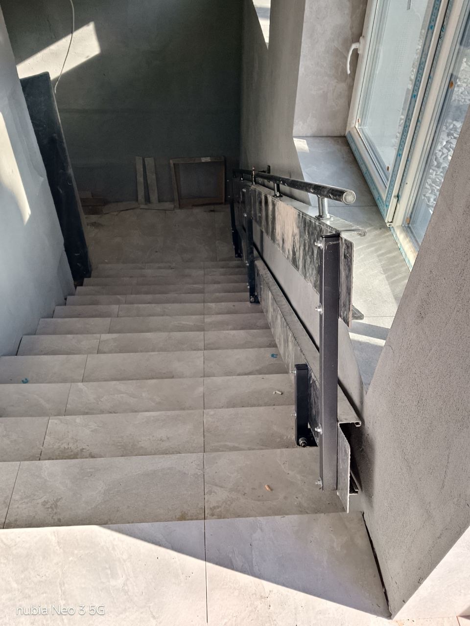 ASPAR fold-down ramp secured beside a wall