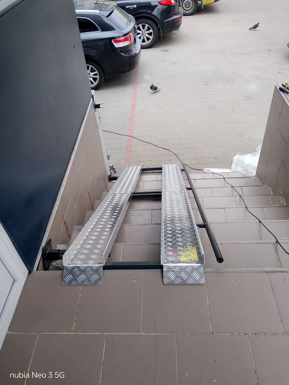 Top view of an ASPAR fold-down ramp at an entrance