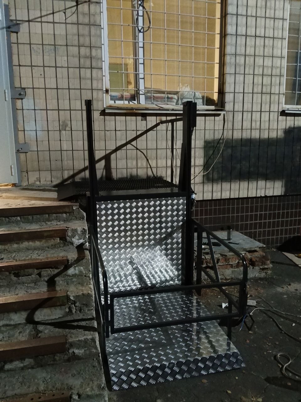 Front view of the vertical lift beside the stairs at a Kyiv hospital